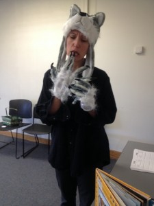 Improv actor C. Berthiaume in wolf hat and white, clawed gloves plays a wolf in Conte-moi ça interactive theatre for kids.